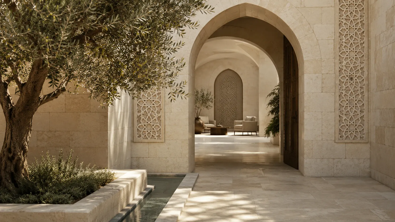 A warm limestone entrance framed by an olive tree, opening toward a calm and welcoming consultation space.